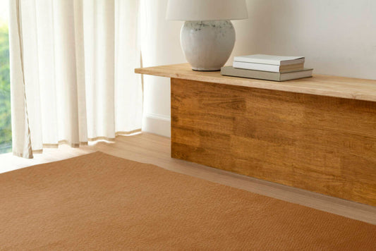 A Brich Plywood Sheet table near by window with white curtain.